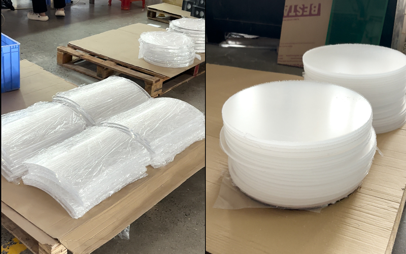 Factory warehouse stacked white foam packaging rolls and empty cartons for acrylic furniture shipping