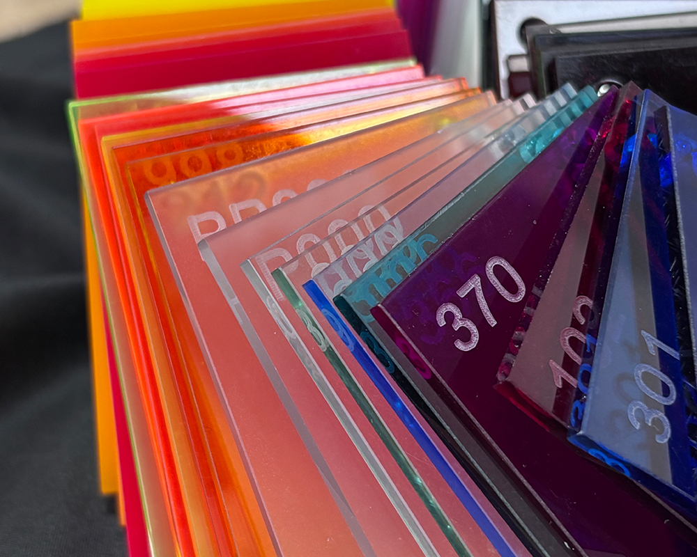 Stacked multi-color gradient translucent acrylic raw material sheets, orange red purple transparent panels