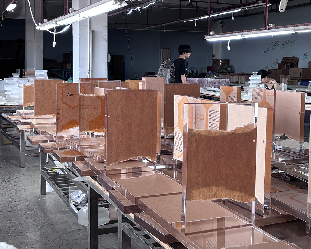 Workstation filled with pre-cut acrylic furniture templates and semi-finished transparent acrylic panels