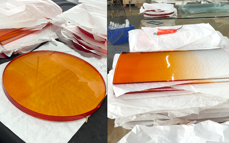 Cut orange gradient acrylic round slab and rectangular panel separated with protective paper, raw material stock shot