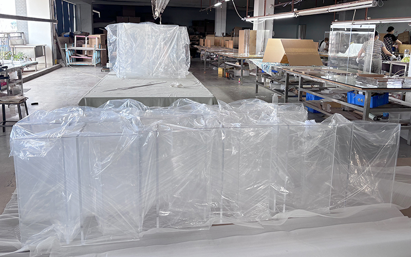Factory production line arranging cut flat acrylic boards for retail shelf assembly