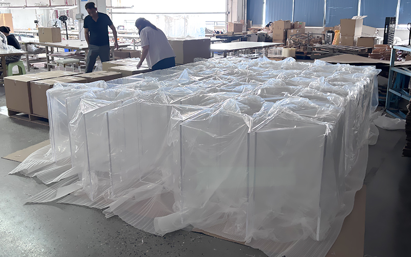 Large batch finished acrylic display boxes wrapped with plastic film ready for shipment