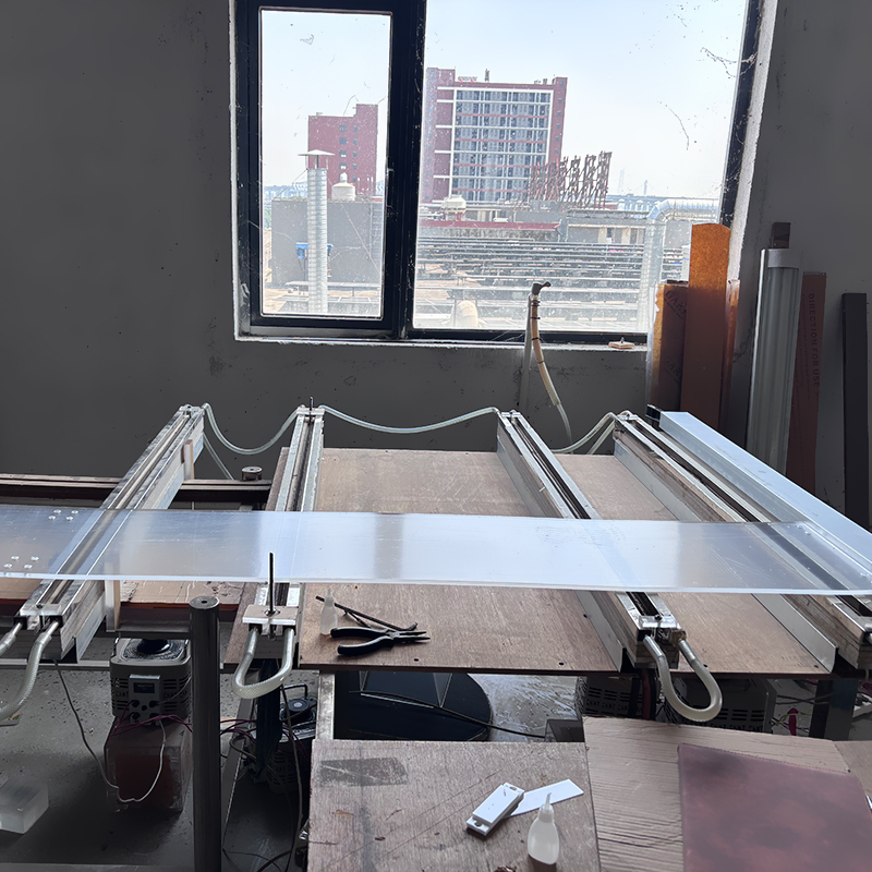 Large flat acrylic sheet production processing workstation inside factory