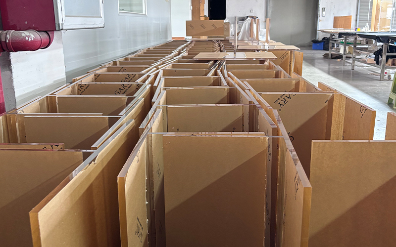 Mass batch of KD flat packed acrylic display frames laid out in factory production area