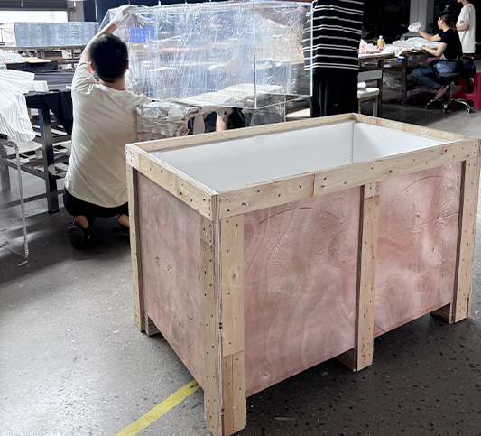 Bespoke-large-acrylic-furniture-being-packed-into-a-sturdy-plywood-crate,-secure-export-packaging-with-internal-foam-protection-for-international-shipping-safety.
