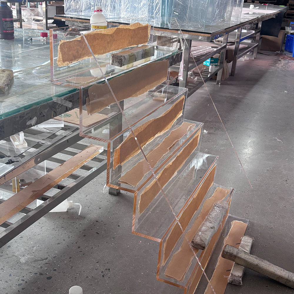 Dedicated assembly stations for large-scale custom acrylic projects.
