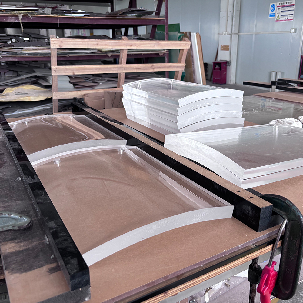 Heavy-gauge curved acrylic panels for luxury retail displays, precision-bent by 20-year fabrication experts.