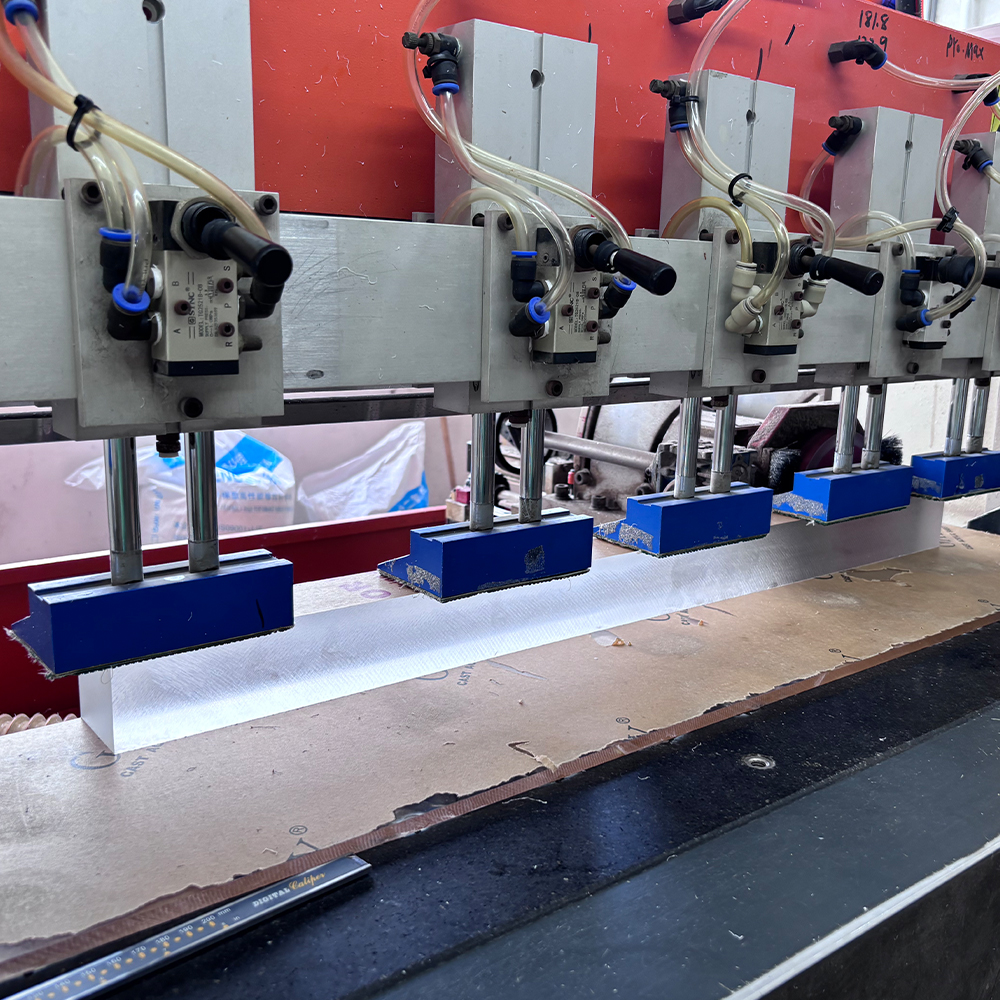 Multi-spindle drilling station for precision batch processing of acrylic parts.