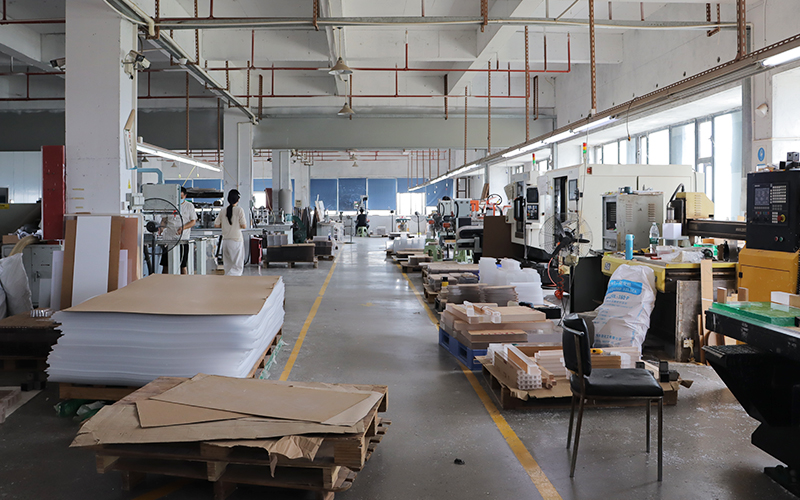 Organized 10,000 sqm acrylic fabrication facility with 5S management and ample material stock.