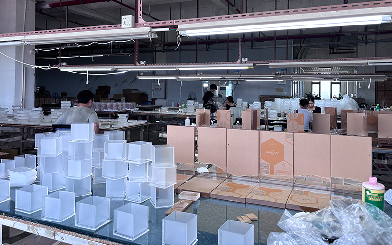 Acrylic Display Box Assembly Workshop with Finished White Boxes and Packaging Materials
