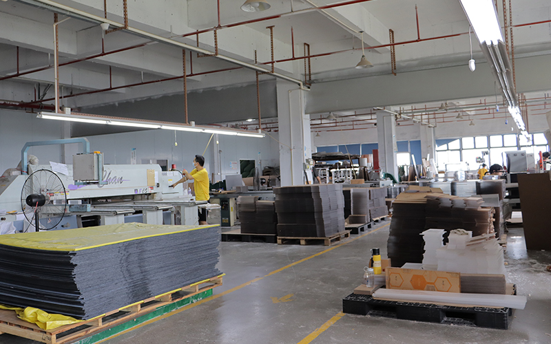 Acrylic Fabrication Workshop with Sheet Stock, Cutting Equipment, and Organized Production Areas
