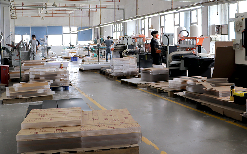 Acrylic Sheet Processing Workshop with CNC Machines, Material Stock, and Production Workstations