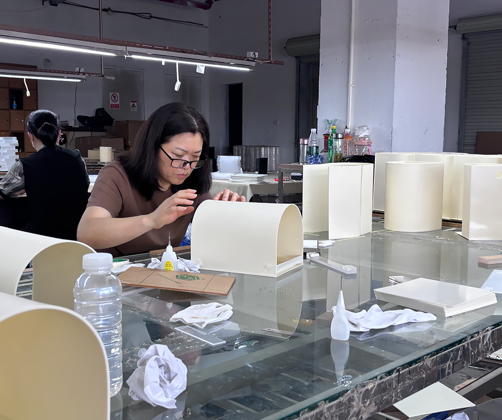 Batch Production of White Curved Acrylic Display Units on a Workbench
