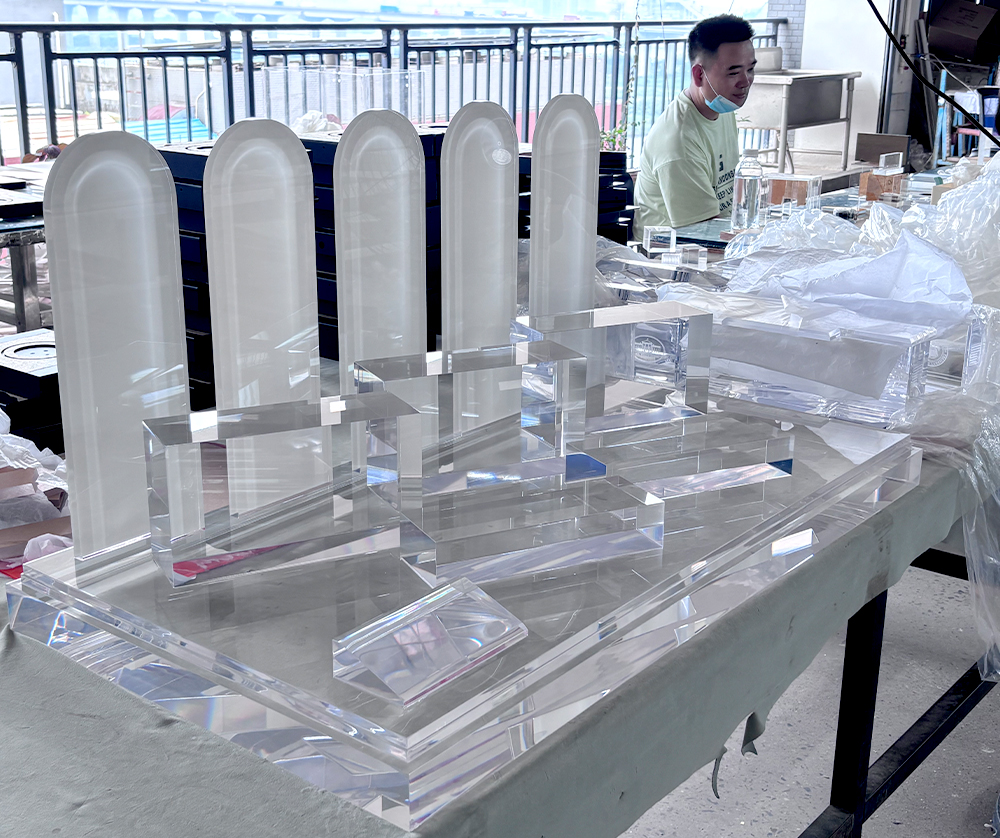 Clear Acrylic Display Fixtures with Frosted Arched Panels on a Factory Workbench