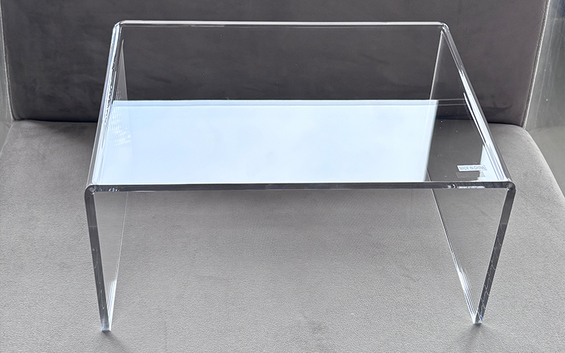 Clear Acrylic Display Table with a Raised Back Panel and Polished Edges