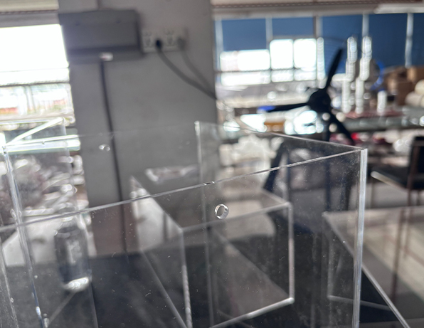 Clear Acrylic Enclosure Panels with Precision-drilled Holes in a Factory Workshop