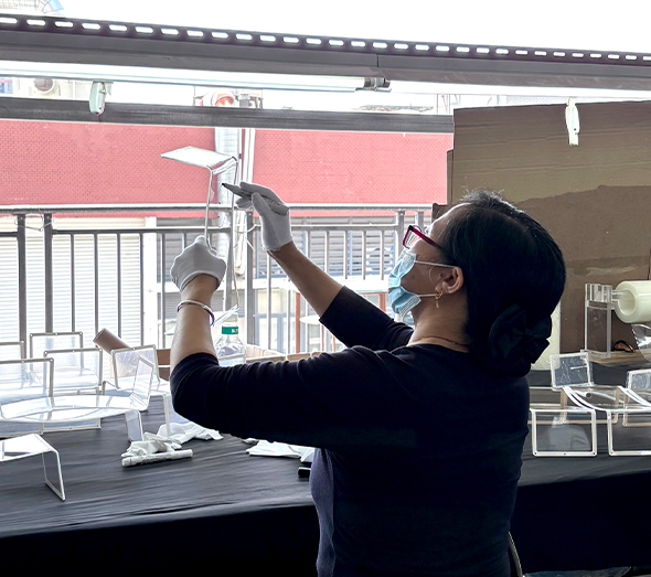 Clear acrylic display stand assembly and quality inspection at a custom manufacturing factory