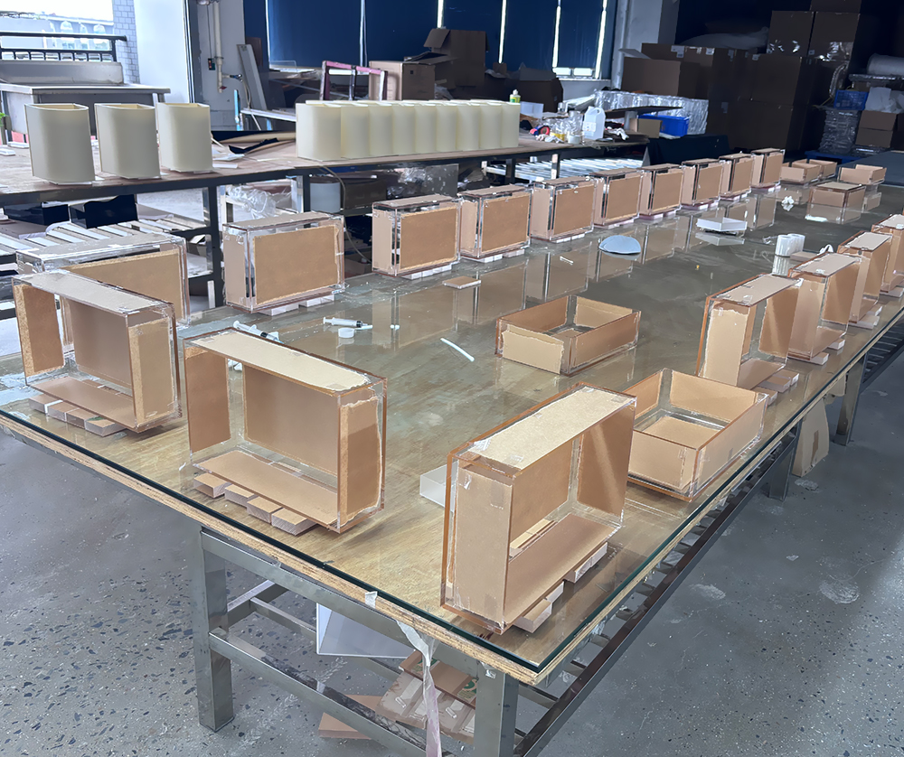 Clear and Amber Acrylic Display Boxes in Various Assembly Stages