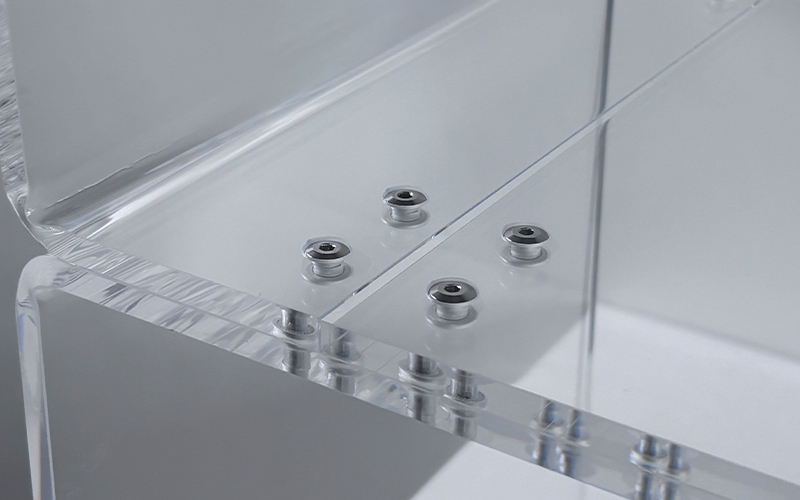 Close-up of Metal Fasteners Securing Clear Acrylic Display Stand Components