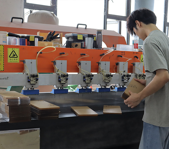 Custom acrylic part drilling with multi-spindle equipment in a manufacturing workshop