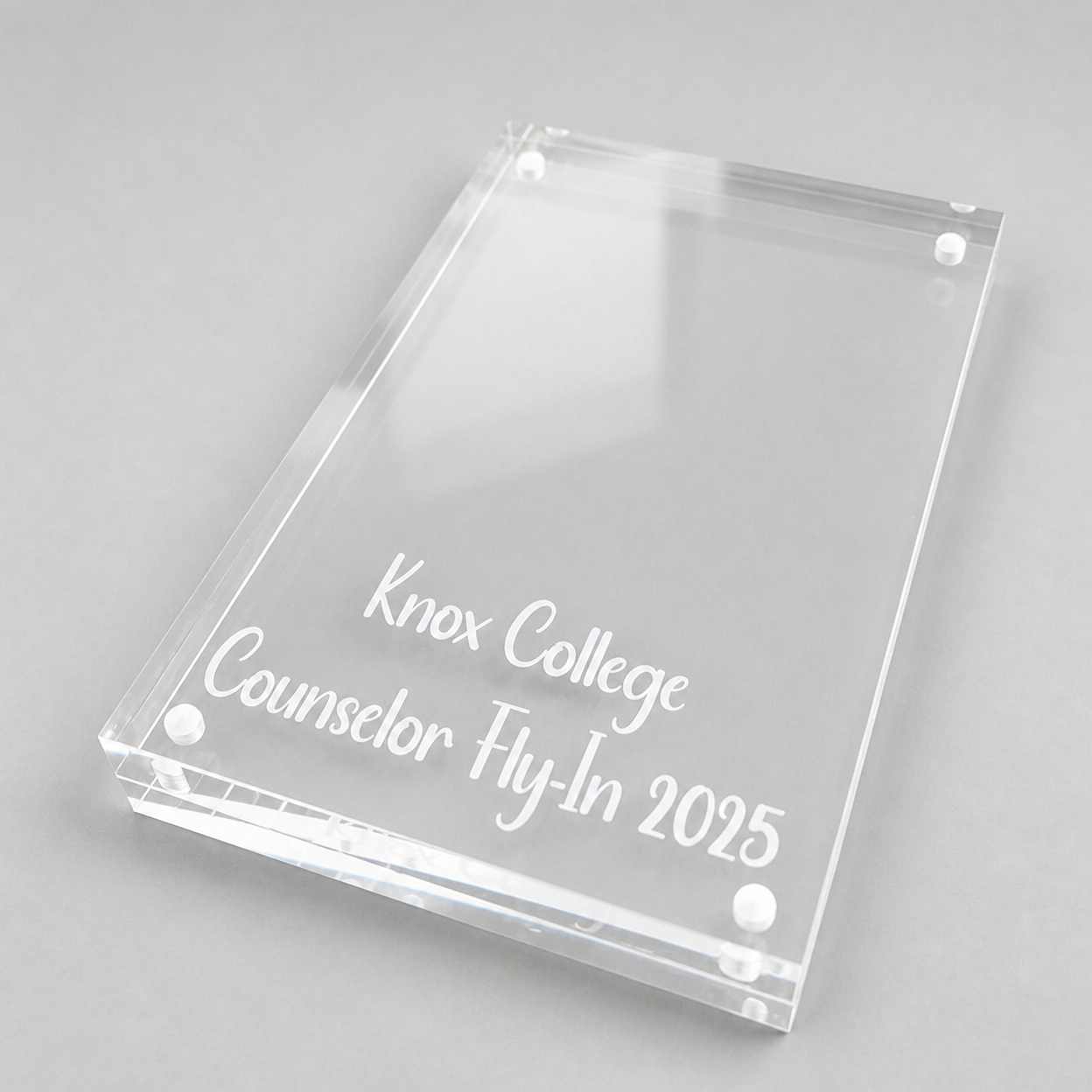 Custom clear acrylic plaque with white lettering for a college event