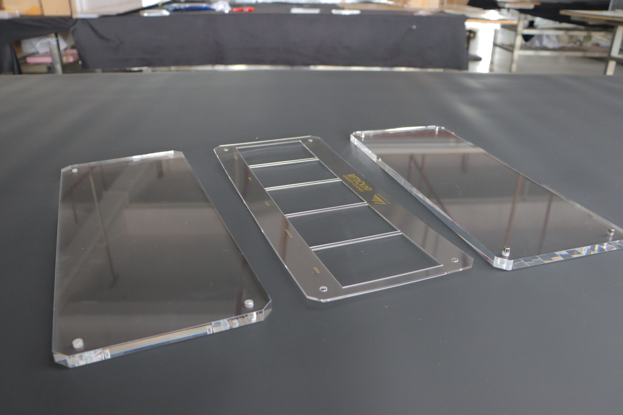Custom clear acrylic panels with CNC-cut openings and mounting holes for equipment covers and displays