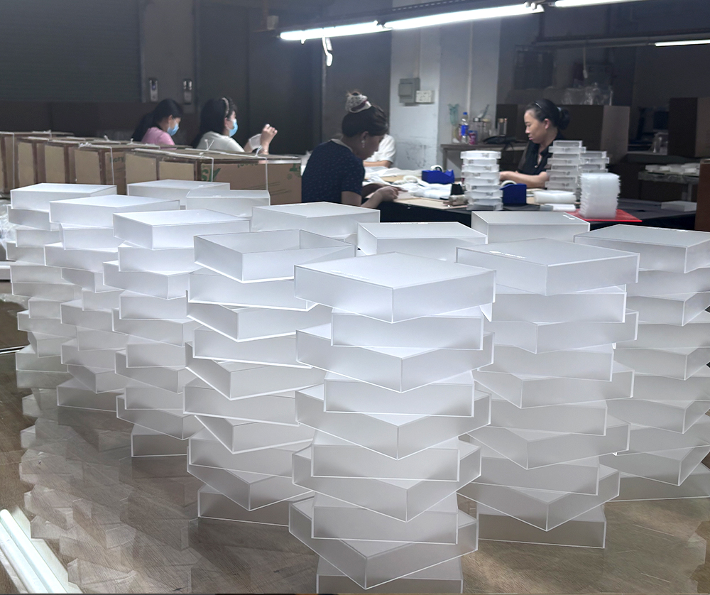 Large Batch of White Acrylic Display Trays on a Production Workbench