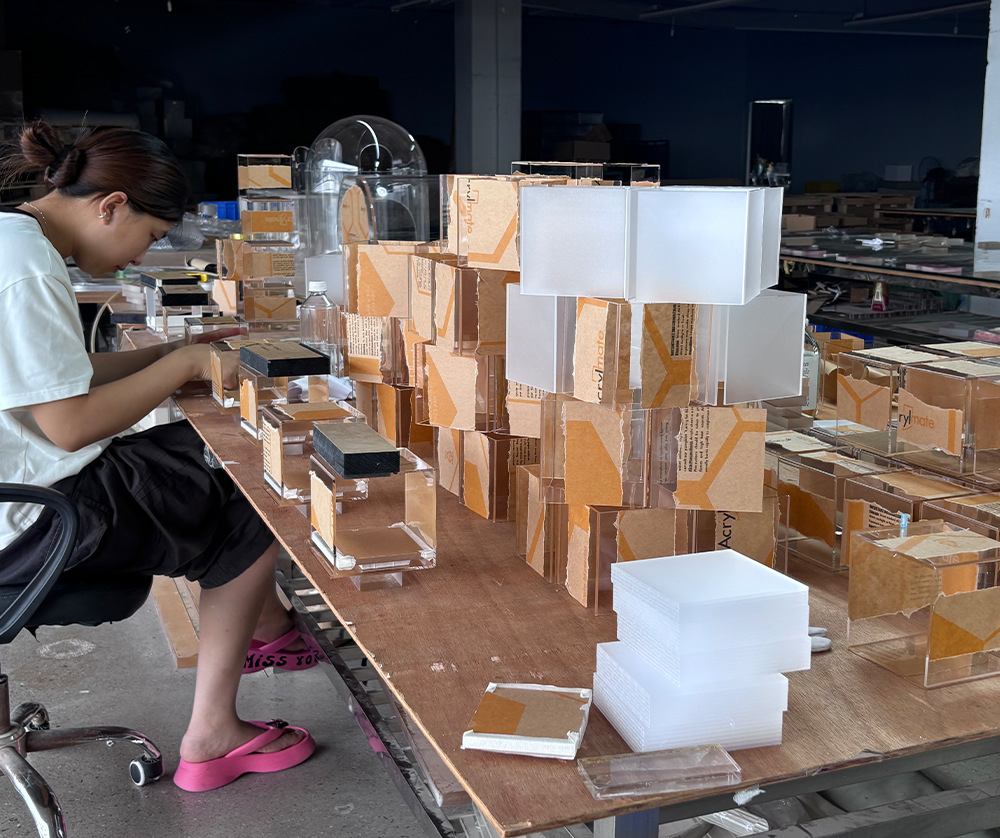 Manual Assembly of Clear Acrylic Display Boxes with Protective Packaging Materials