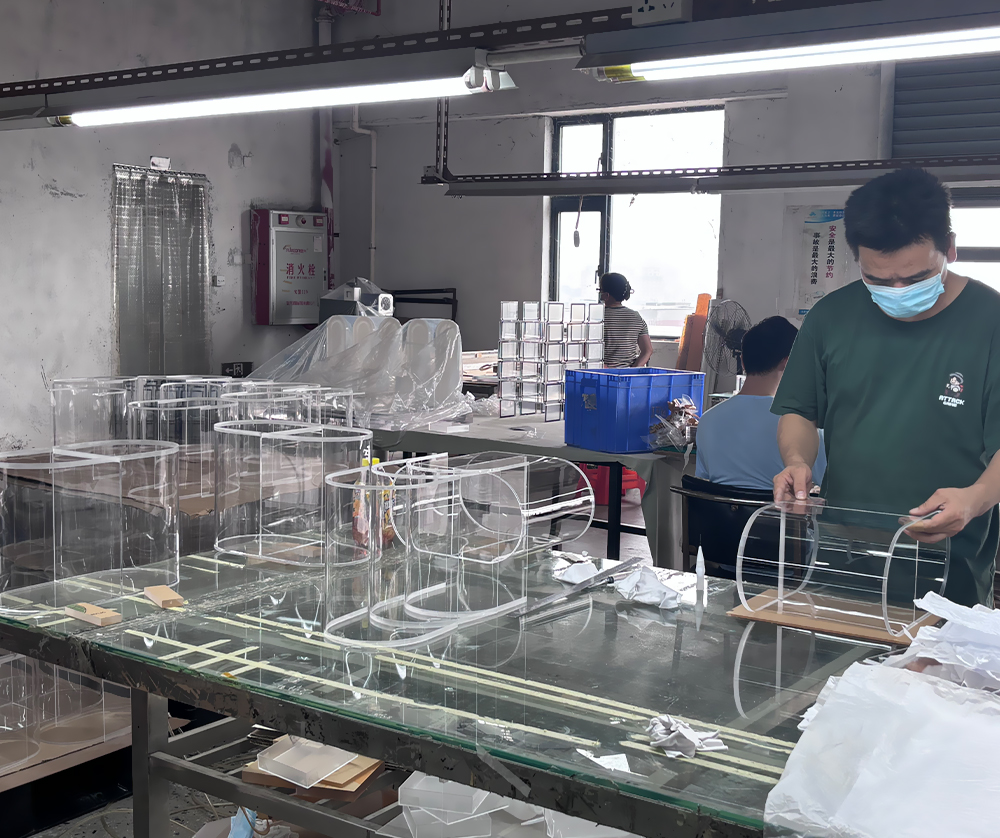 Manual Assembly of Curved Acrylic Display Components in a Manufacturing Facility