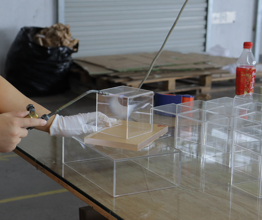 Manual Finishing of Small Clear Acrylic Display Boxes in a Factory Workshop