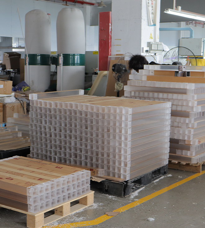 Palletized Acrylic Components with Protective Grid Packaging in a Manufacturing Workshop