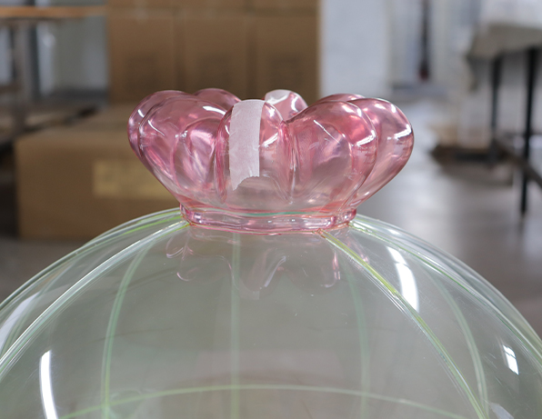 Pink Crown-shaped Acrylic Top Detail on a Transparent Pet Enclosure