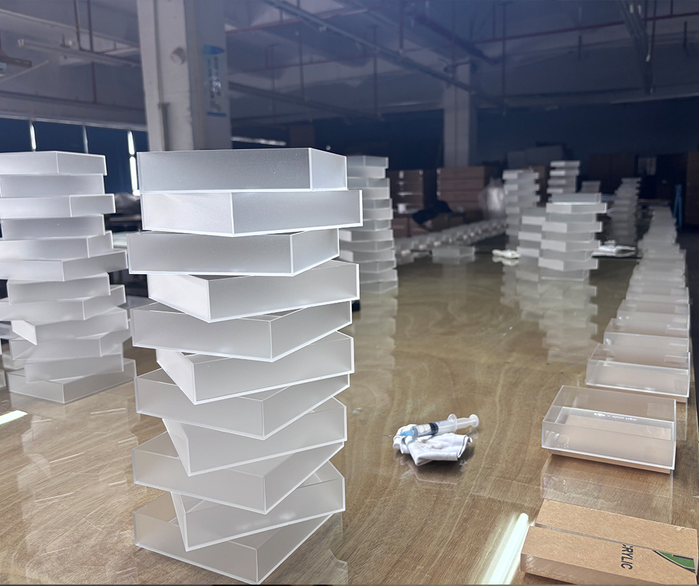 Stacked White Acrylic Tray Boxes Prepared for Batch Production