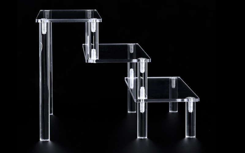 Staggered Clear Acrylic Display Stand with Multiple Levels and Round Support Legs