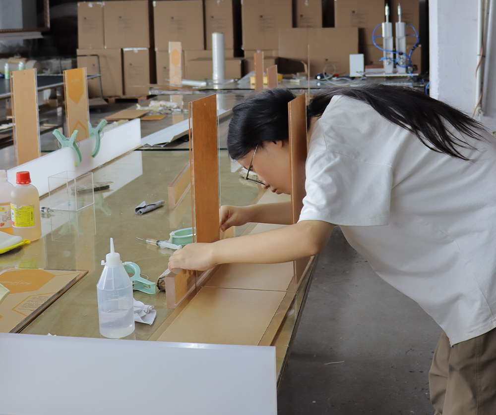 White Acrylic Grid Organizer with Multiple Compartments in a Production Workshop