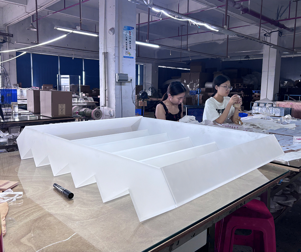 White Acrylic Multi-tier Display Organizer Being Assembled in a Factory Workshop