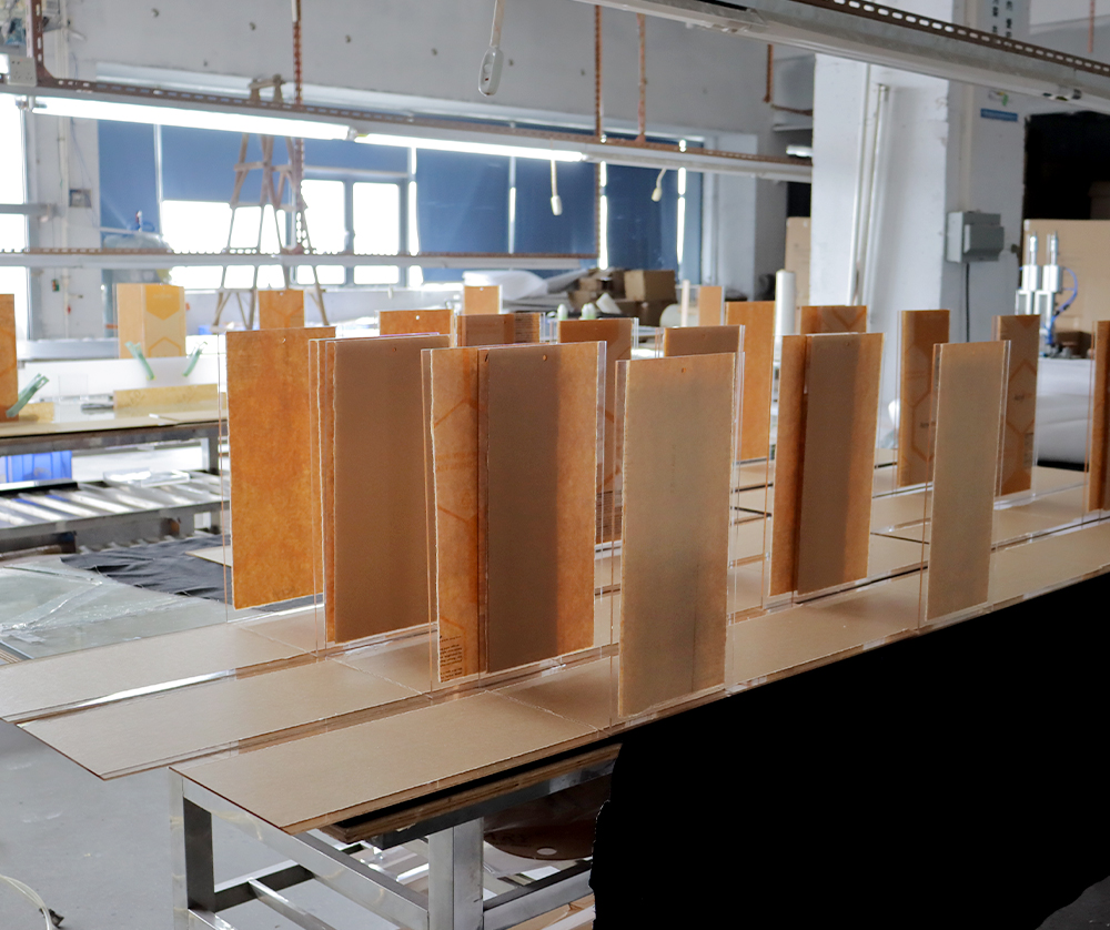 Worker Assembling a Clear Acrylic Display Box on a Factory Workbench