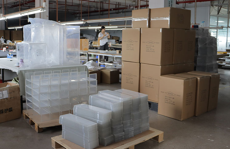 Acrylic furniture factory with packaged products and shipping cartons