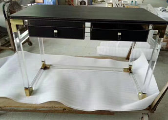 Black acrylic writing desk with clear legs
