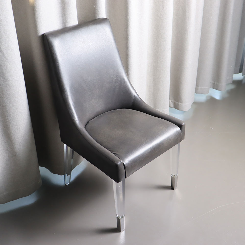 Black upholstered dining chair with clear acrylic legs