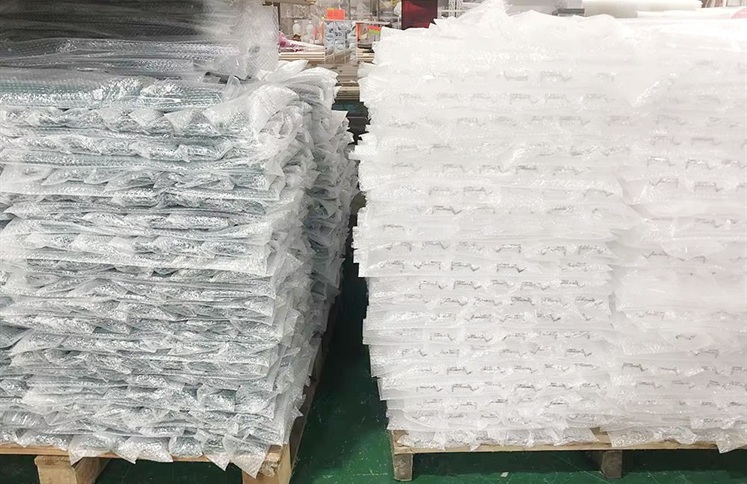 Bulk acrylic mahjong racks in protective bubble wrap on pallets