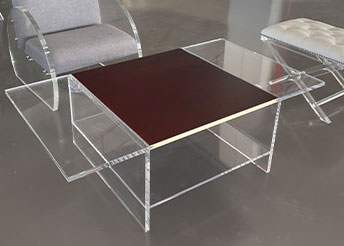 Clear acrylic coffee table with dark wood top