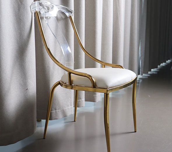 Clear acrylic dining chair with gold frame and white cushion