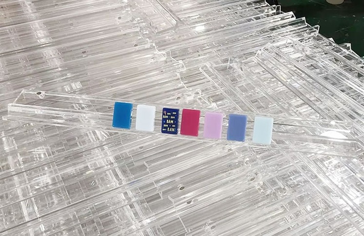 Clear acrylic mahjong tile racks on factory production line
