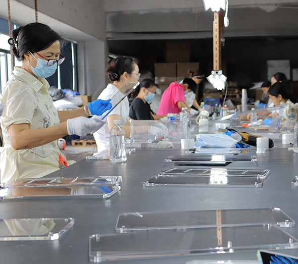 Clear acrylic panel assembly and quality inspection at a custom acrylic manufacturing factory