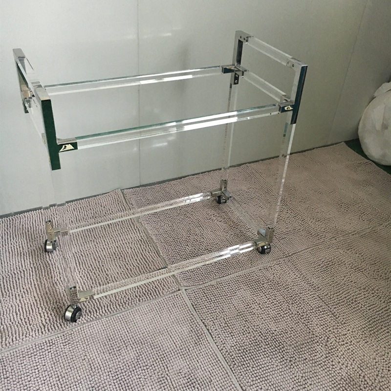 Clear acrylic service cart frame with chrome corner brackets and wheels
