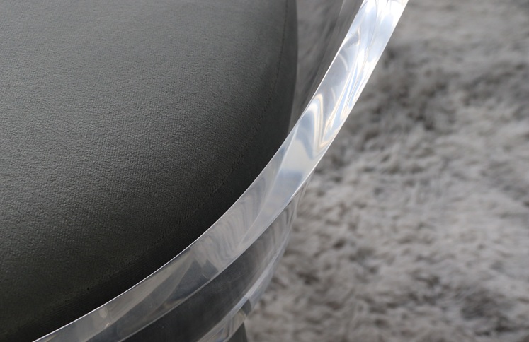 Curved clear acrylic chair frame with grey upholstered cushion detail