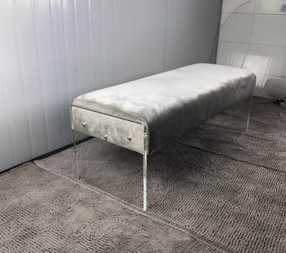 Grey velvet upholstered bench with clear acrylic panel legs