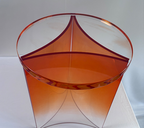Orange acrylic side table with curved transparent structure