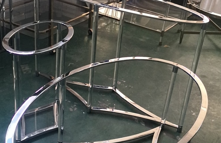 Oval chrome metal frame coffee table with clear acrylic legs